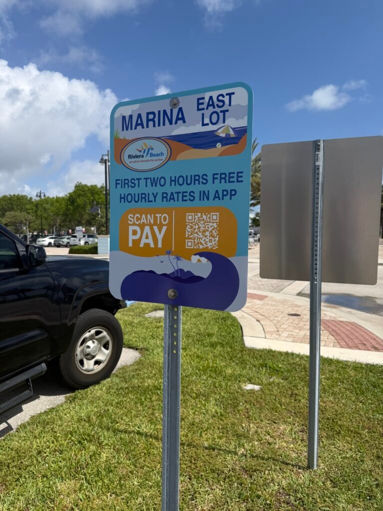 Riviera Beach Marina East Lot parking sign: first two hours free, scan QR code to pay